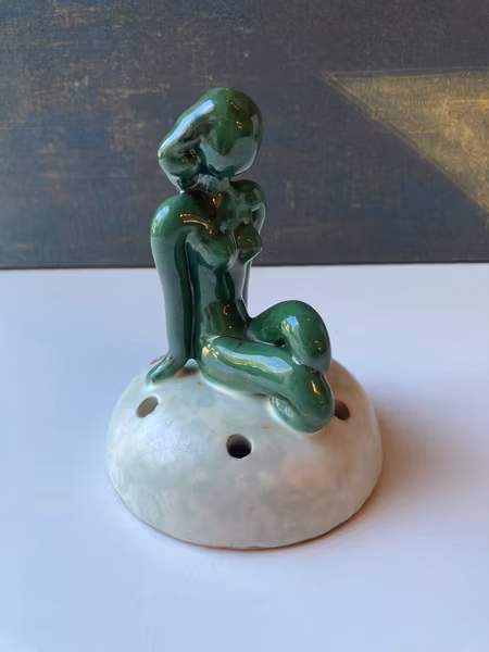 Green lady on greyish flower holder 30