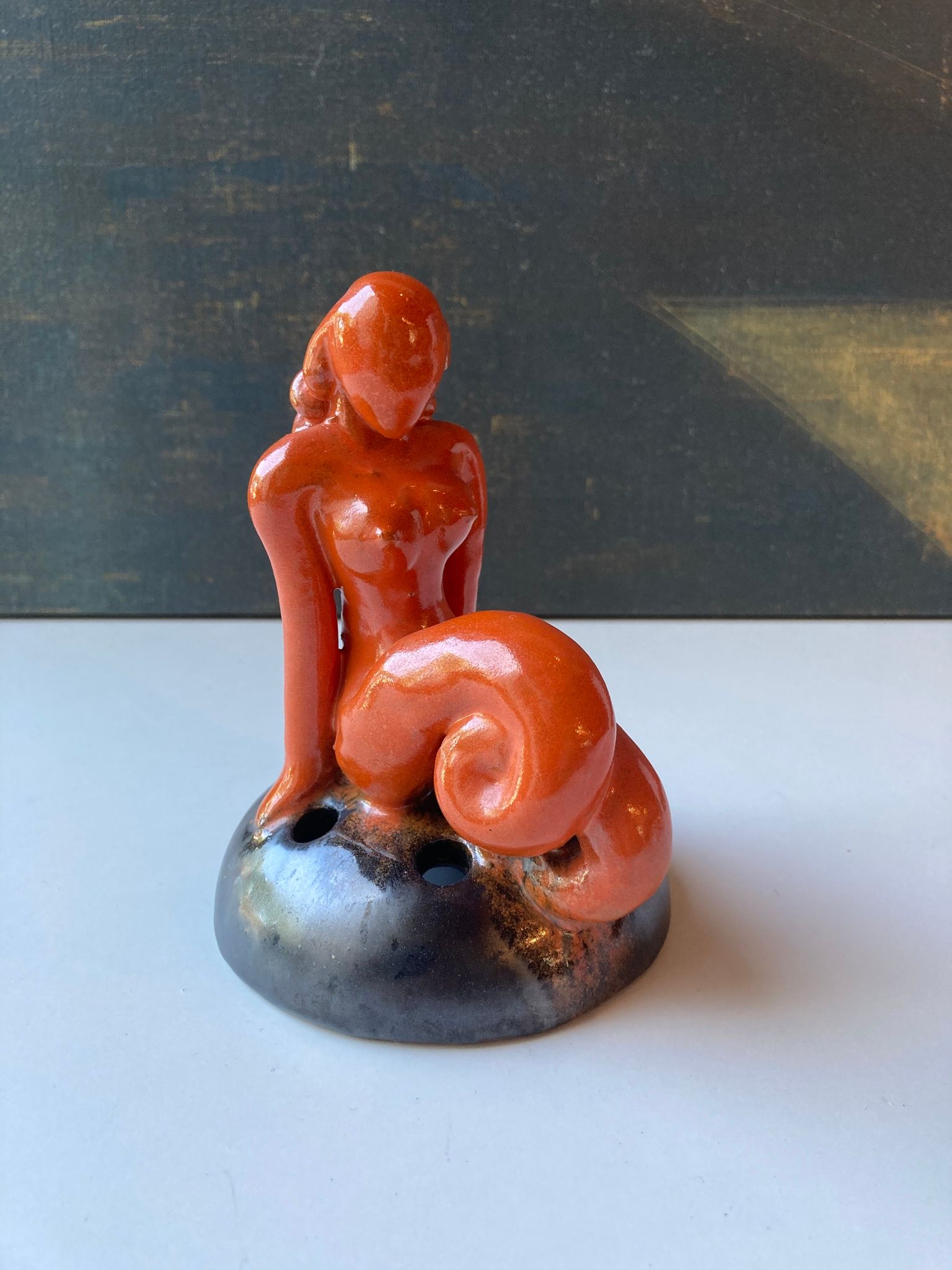 Orange lady on black flower holder