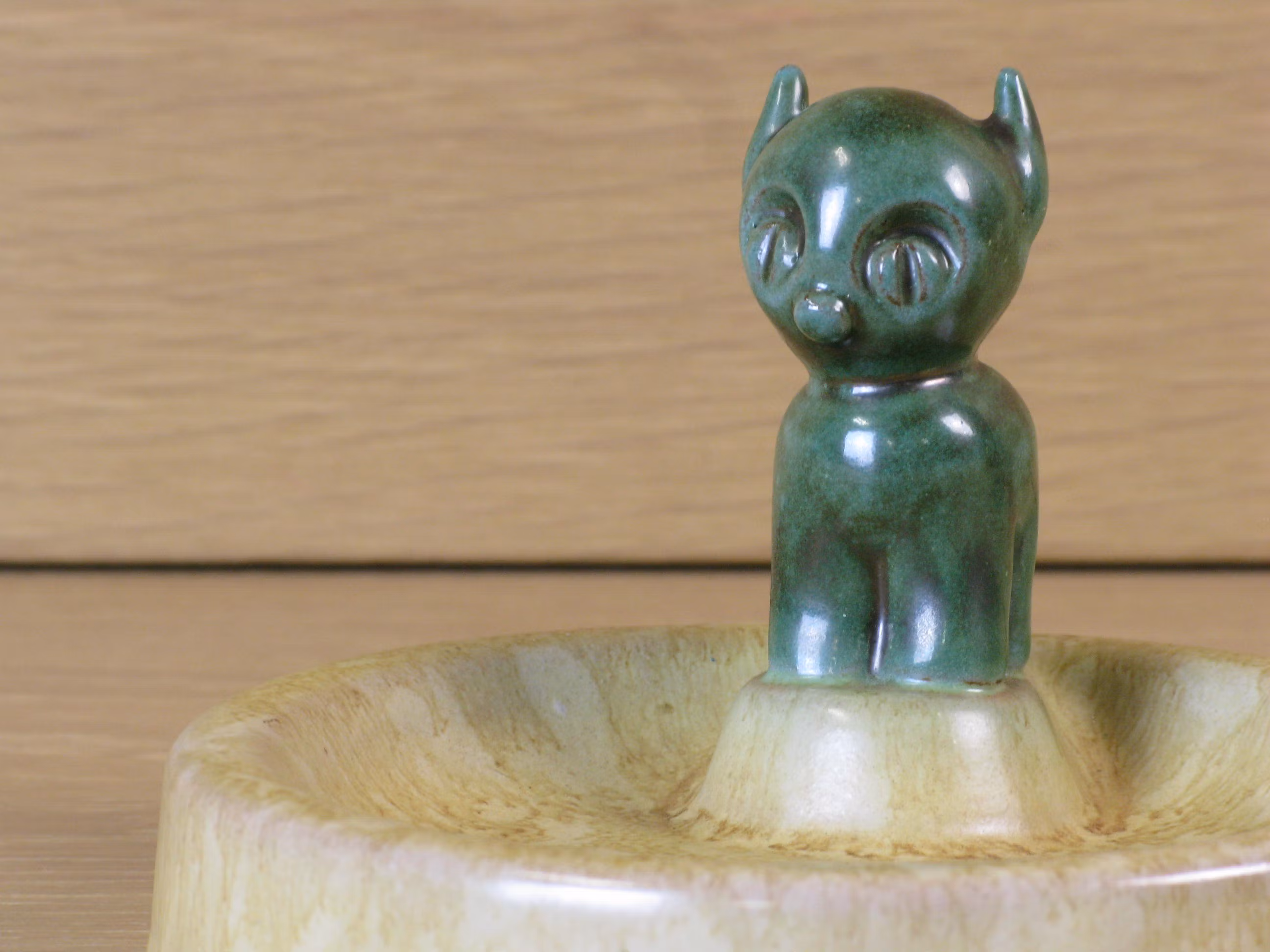 Green cat in ashtray 49