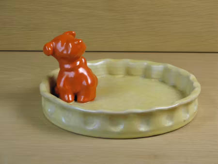 orange dog in yellowish ashtray 12