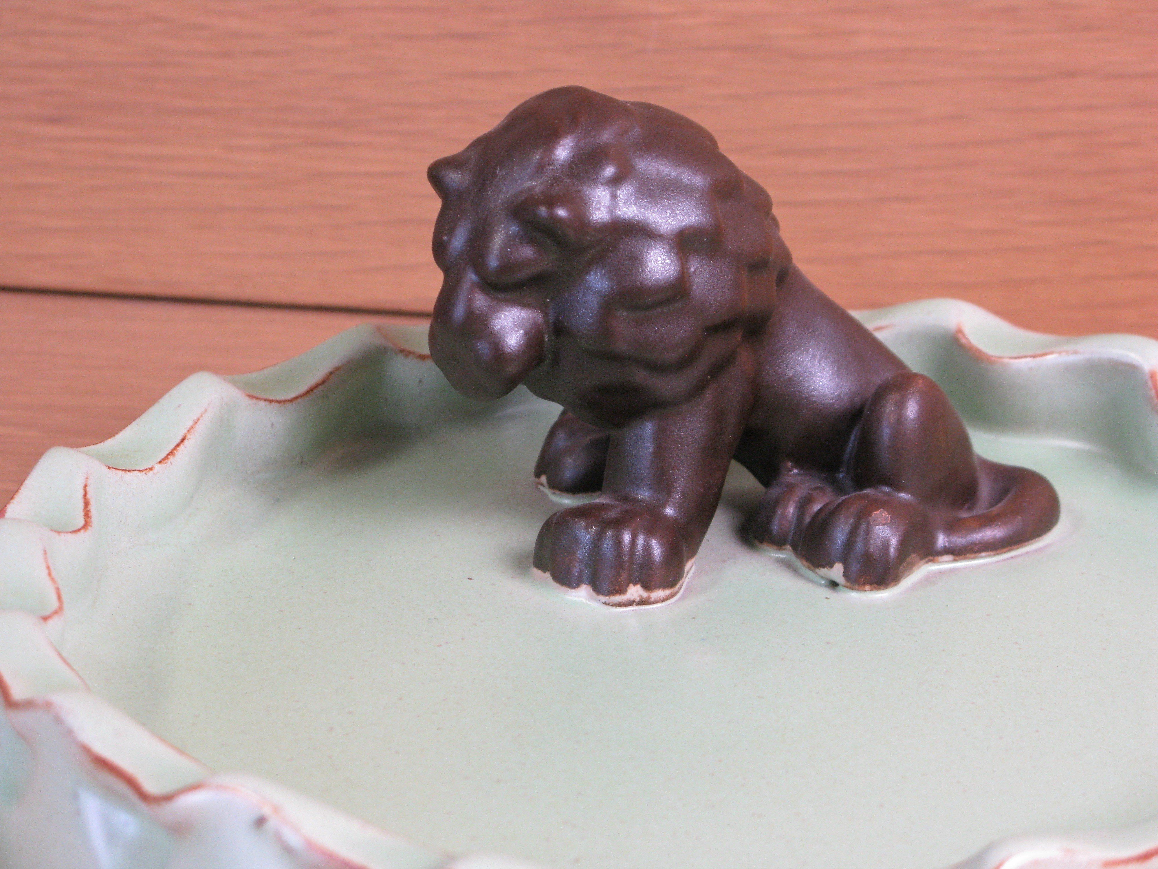brown lion in green ashtray 12