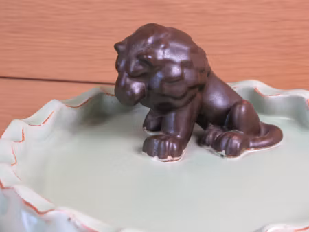 brown lion in green ashtray 12