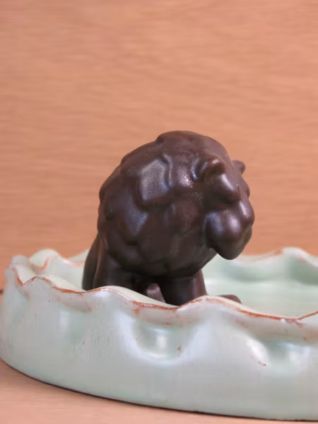 brown lion in green ashtray 12