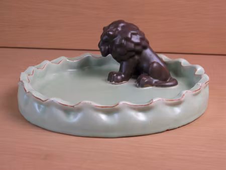 brown lion in green ashtray 12