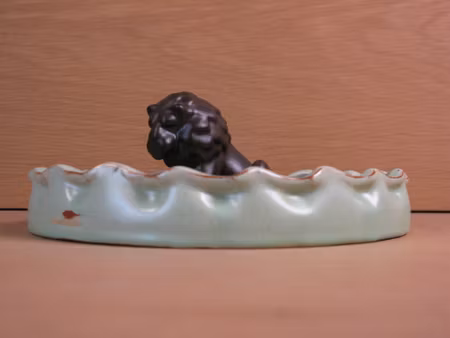 brown lion in green ashtray 12