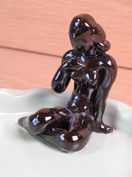 brown lady in green ashtray 12