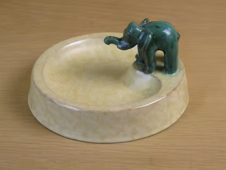 green elephant on yellowish bowl