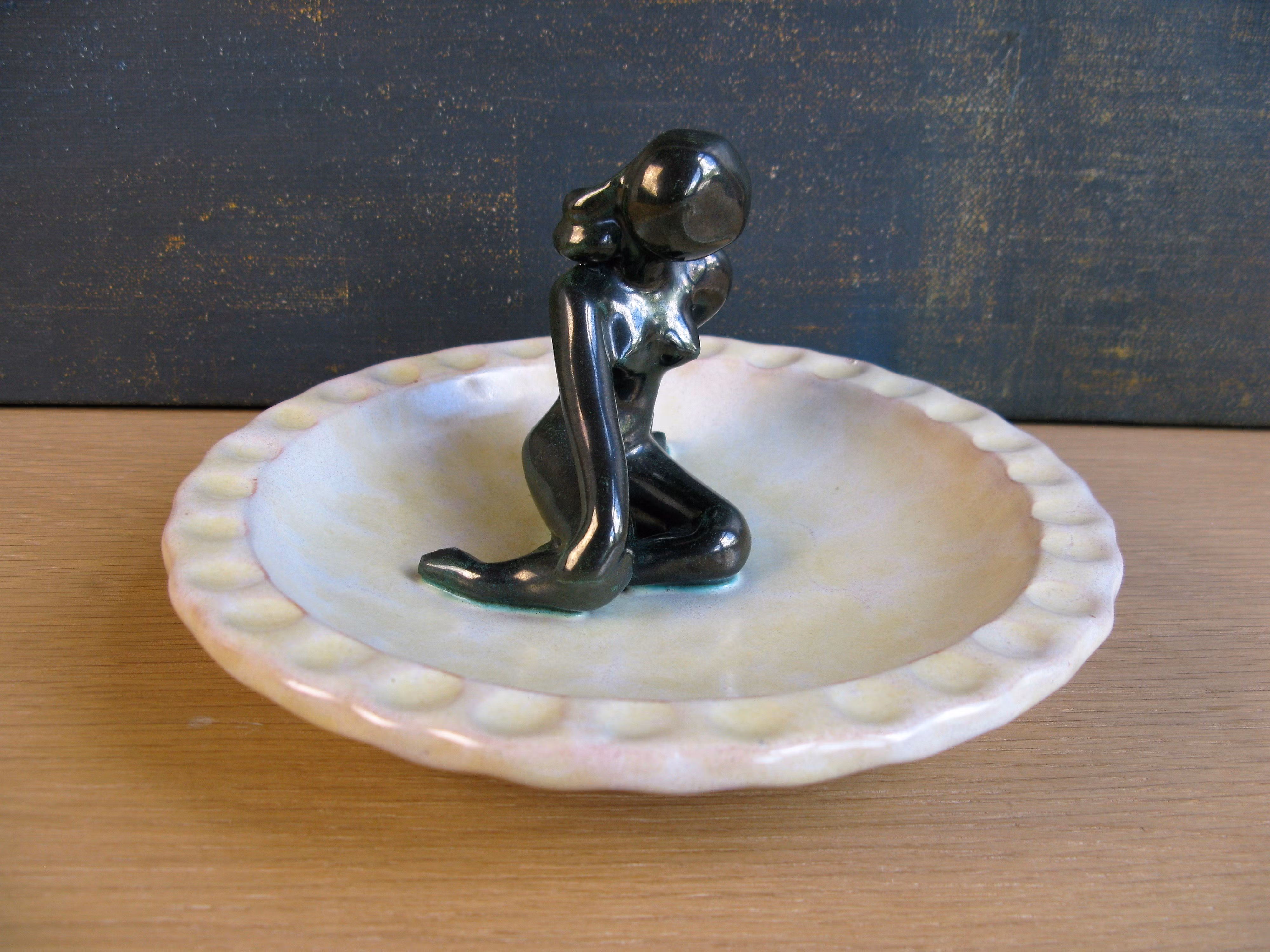 green lady in yellowish ashtray 33