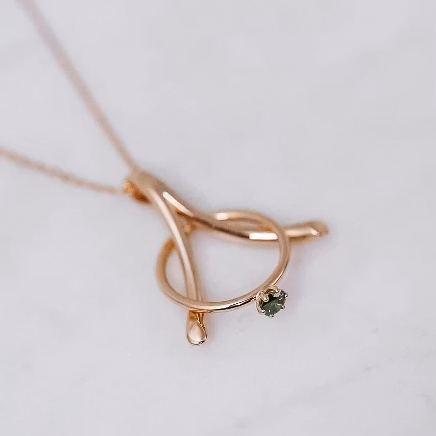 "Wishbone" ring holding pendant in gold