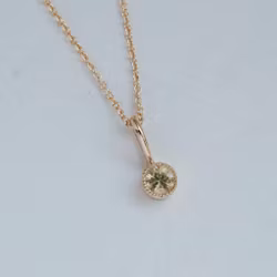 "Twinkle" pendant in gold with a light yellow sapphire