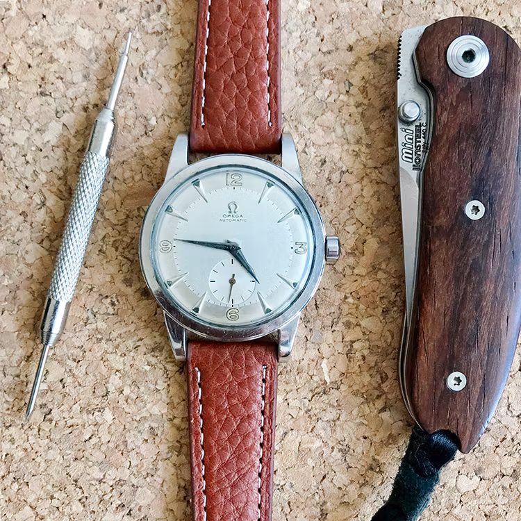 Klockarmband av brunt läder med vit söm