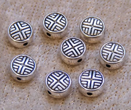 Mellandel, mönstrad coin, antiksilver